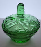 Green covered glass bowl with lid glows