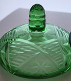 Green covered glass bowl with lid glows